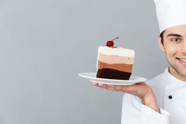 Chef holding a slice of cake revealing its layers