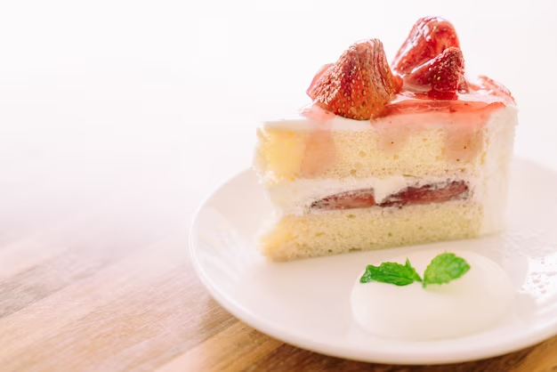 A piece of strawberry tres leches cake featuring caramelized strawberries on the top