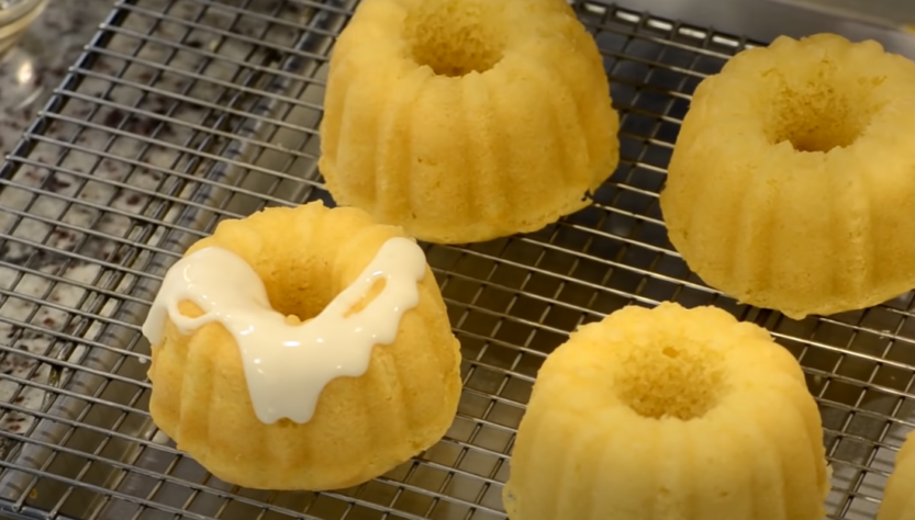 Mini Bundt Cakes, one with vanilla frosting on top