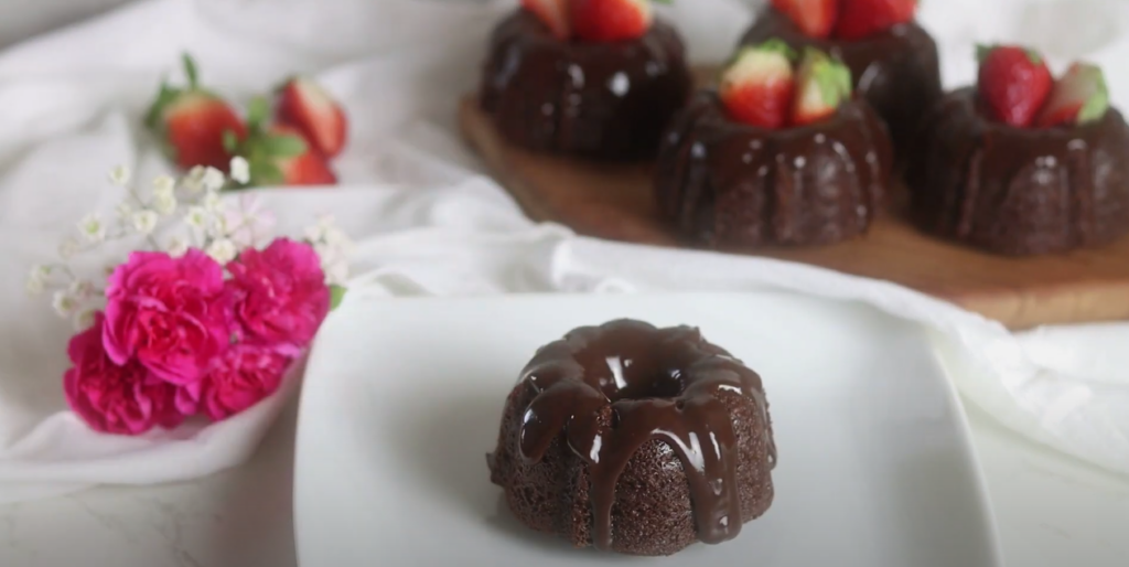 Decadent Chocolate Elegance on a plate, with another in the background topped with strawberries