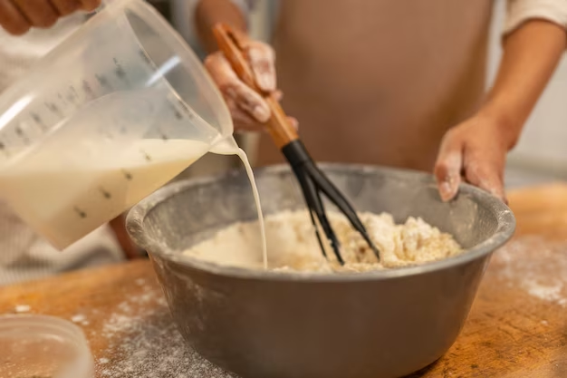 Pouring Milk into Bowl with Mixture